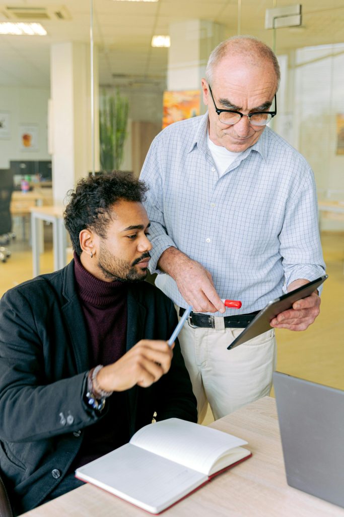 Zwei Kollegen führen eine produktive Diskussion in einer modernen Büroumgebung.